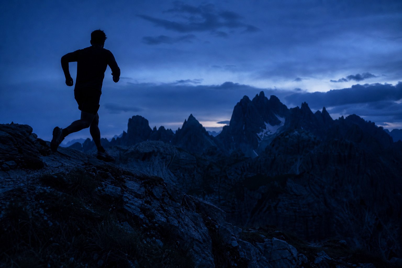 Runner on a mountain ridge at dusk